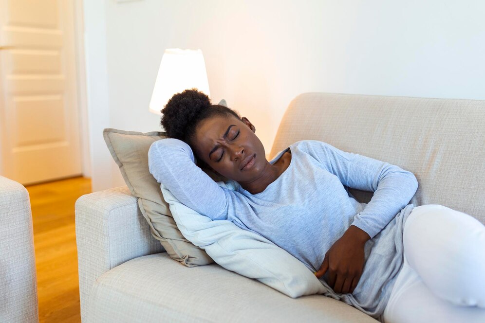 woman-lying-sofa-looking-sick-living-room