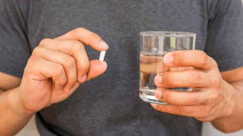 man taking supplement