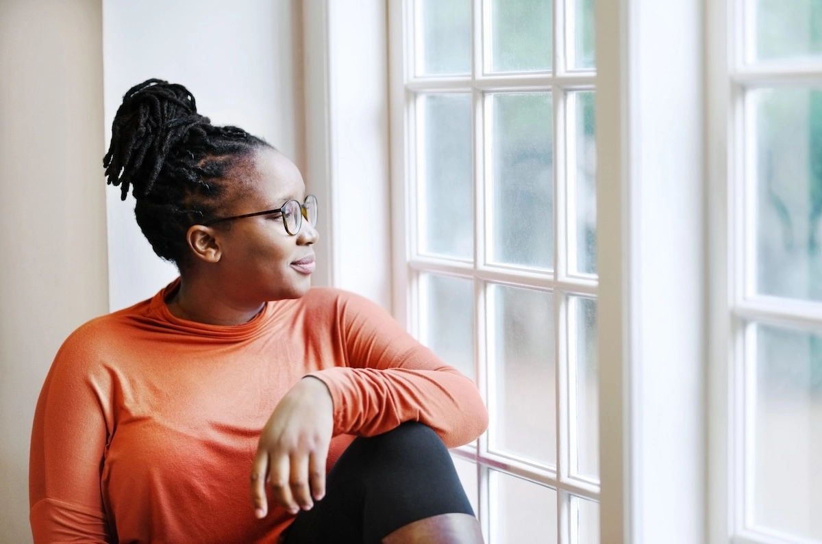 woman looking out window